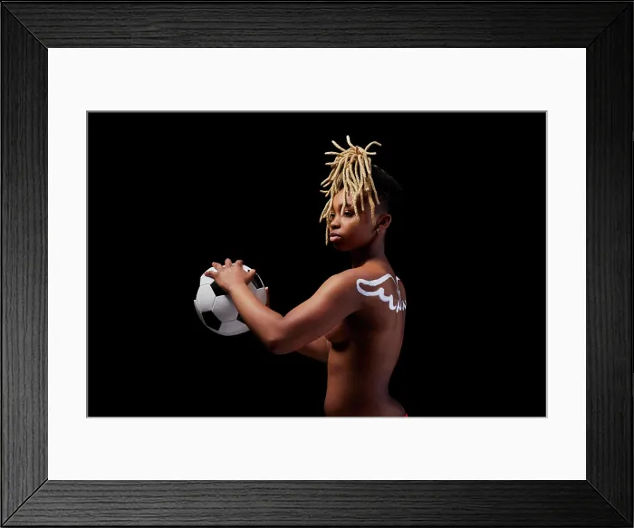 Framed Print : Female athlete with painted wings on her back holding a soccer ball Framed Print : Female athlete with painted wings on her back holding a soccer ball