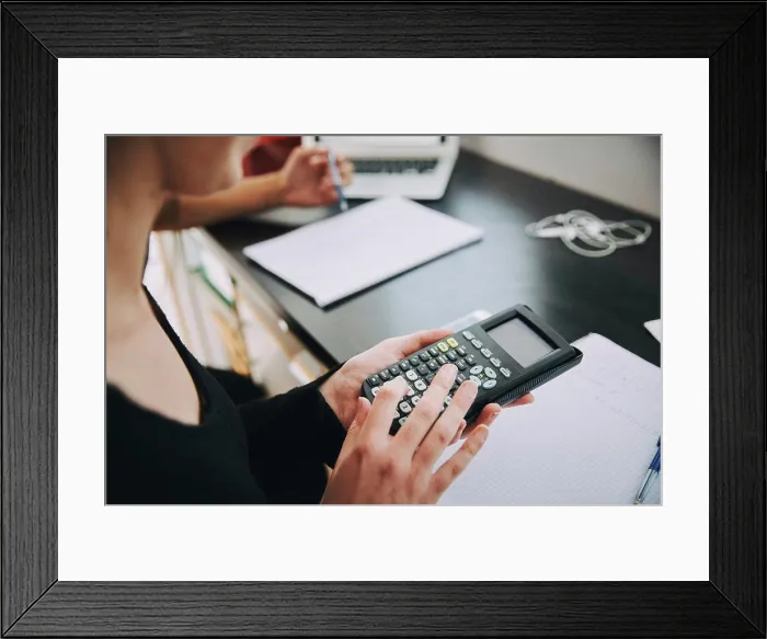 Framed Print : Midsection of young female student using calculator in classroom at university Framed Print : Midsection of young female student using calculator in classroom at university