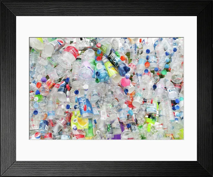 Framed Print : Environment, Recycling, Plastic bottles attached to a wire fence at the WOMAD festival Framed Print : Environment, Recycling, Plastic bottles attached to a wire fence at the WOMAD festival