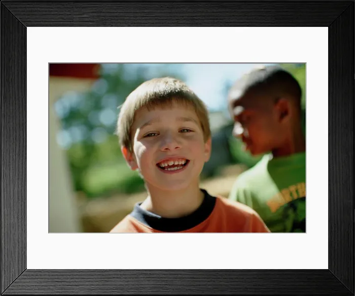 Framed Print : Portrait of a smiling young boy Framed Print : Portrait of a smiling young boy