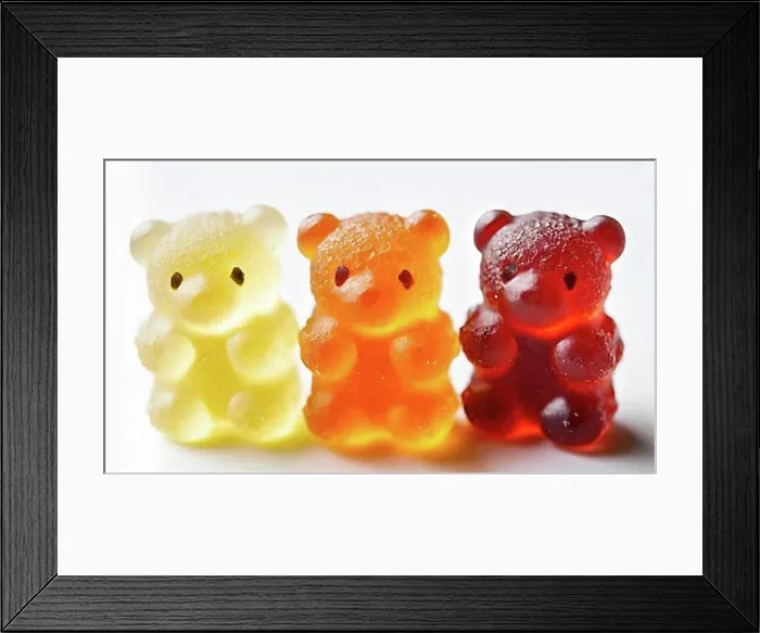 Framed Print : Transparent gummy bears in the colours yellow