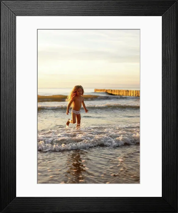 Framed Print : Cute girl wearing underwear playing in water on beach