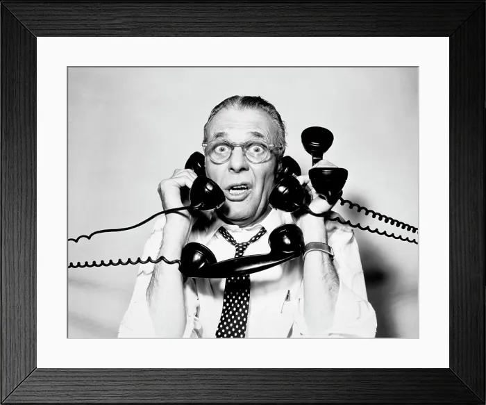 Framed Print : 1950S 1960S Portrait Of Frazzled Businessman Trying To Answer Four Black Telephones Phones At Once Framed Print : 1950S 1960S Portrait Of Frazzled Businessman Trying To Answer Four Black Telephones Phones At Once