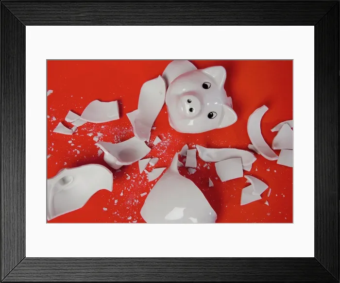 Framed Print : A smashed empty piggy bank