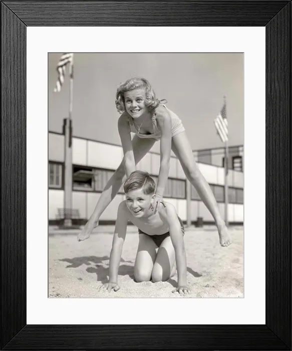 Framed Print : 1930s 1940s SMILING GIRL AND BOY PLAYING LEAP FROG ON SAND BEACH BROTHER KNEELING BLONDE SISTER JUMPING OVER HIS BACK Framed Print : 1930s 1940s SMILING GIRL AND BOY PLAYING LEAP FROG ON SAND BEACH BROTHER KNEELING BLONDE SISTER JUMPING OVER HIS BACK