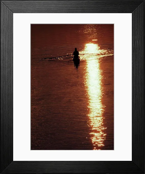 Framed Print : Silhouette of a man rowing a boat amidst the river Framed Print : Silhouette of a man rowing a boat amidst the river