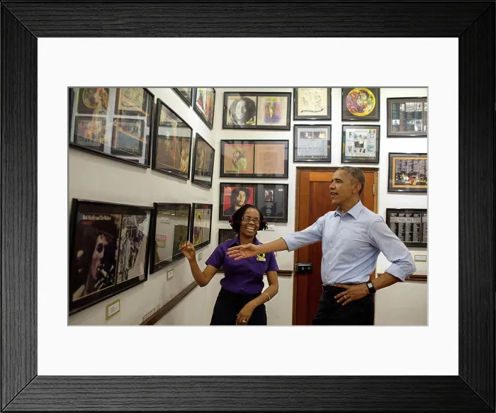 Framed Print : President Barack Obama looks at memorabilia with museum guide Natasha Clark at the Bob Marley Museum in Kingston