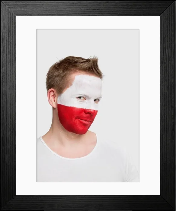 Framed Print : London, UK. Portrait of young man with Polish flag painted on face smiling against white background Framed Print : London, UK. Portrait of young man with Polish flag painted on face smiling against white background