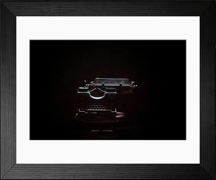 Framed Print : Typewriter on table against black background Framed Print : Typewriter on table against black background
