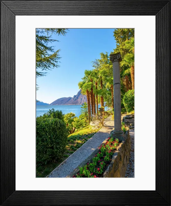 Framed Print : Walkway with Column on Lake Lugano with Mountain Peak and Palm Tree in a Sunny Day with Clear Sky in Lugano