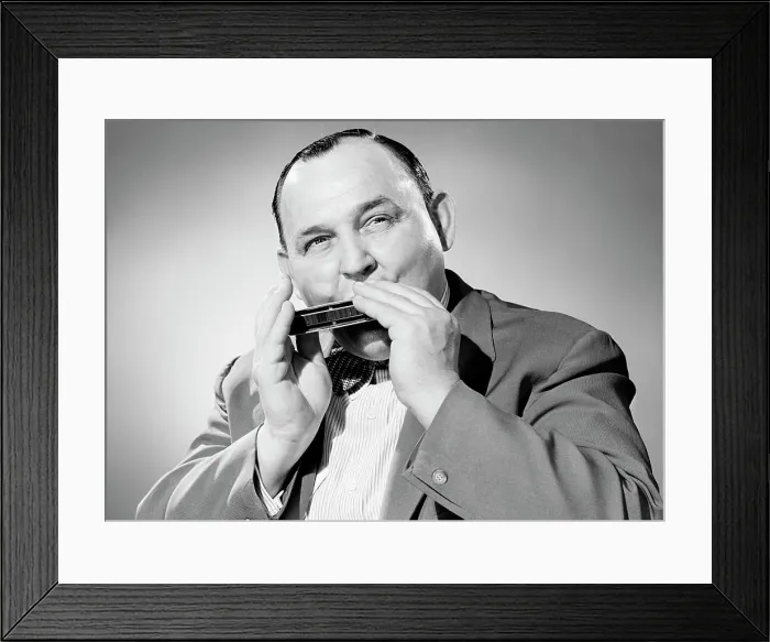 Framed Print : Portrait of man playing on harmonica Framed Print : Portrait of man playing on harmonica