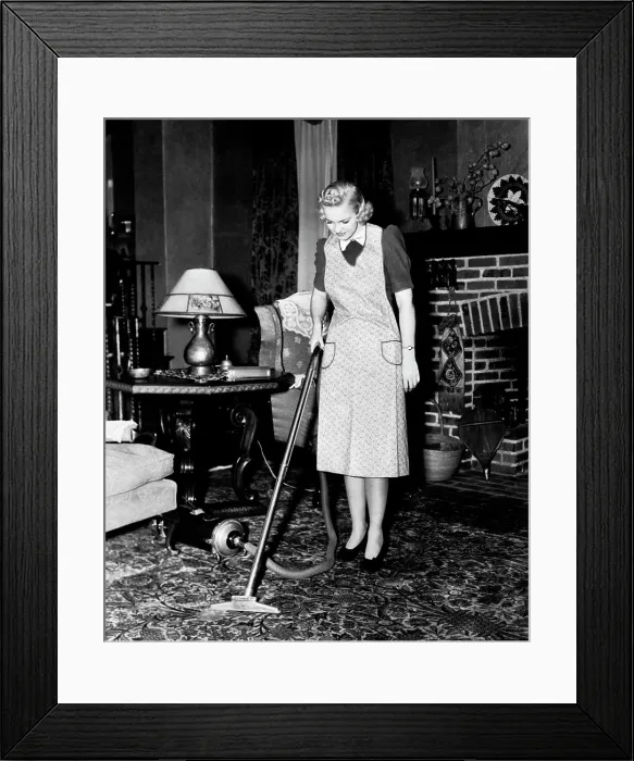 Framed Print : 1930S 1940S Woman Housewife Wearing Apron Pushing Electric Vacuum Cleaner In Ornate Living Room House Chore Framed Print : 1930S 1940S Woman Housewife Wearing Apron Pushing Electric Vacuum Cleaner In Ornate Living Room House Chore