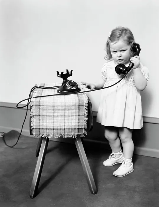Framed Print : 1930S 1940S Unhappy Frowing Little Girl Takling On Old Black Rotary Dial Telephone