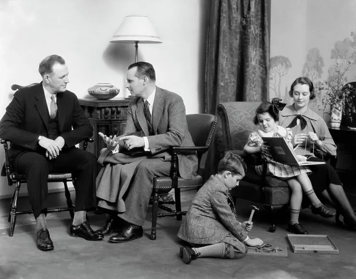 Framed Print : 1930S Family In Living Room Mother Knits Daughter On Her Lap With Book Son On Floor With Hammer