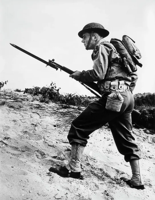 Framed Print : 1940S 1942 World War Ii Soldier Walking Across Rough Terrain With Rifle And Bayonet In Hand Framed Print : 1940S 1942 World War Ii Soldier Walking Across Rough Terrain With Rifle And Bayonet In Hand
