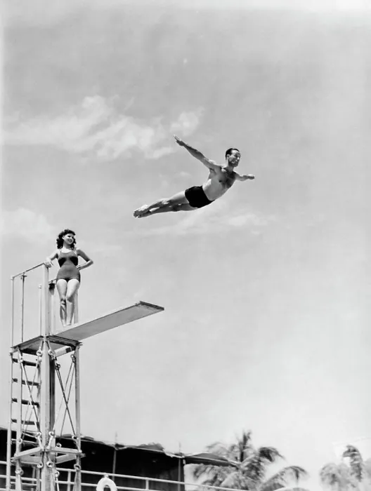 Framed Print : 1940S Man Swan Diving Off High Diving Board Woman Watching Framed Print : 1940S Man Swan Diving Off High Diving Board Woman Watching