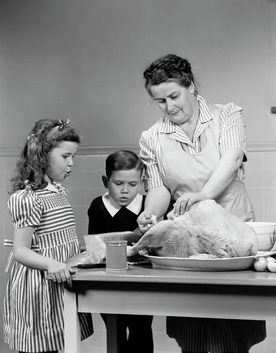 Framed Print : 1940S Mother Son Daughter In Kitchen Stuffing Turkey For Thanksgiving Dinner Framed Print : 1940S Mother Son Daughter In Kitchen Stuffing Turkey For Thanksgiving Dinner