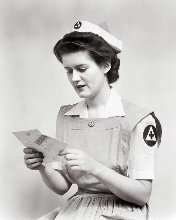 Framed Print : 1940s WOMAN SERVING VOLUNTEER RED CROSS NURSE WEARING UNIFORM SMOCK DRESS AND CAP READING LETTER DURING WORLD WAR 2 Framed Print : 1940s WOMAN SERVING VOLUNTEER RED CROSS NURSE WEARING UNIFORM SMOCK DRESS AND CAP READING LETTER DURING WORLD WAR 2