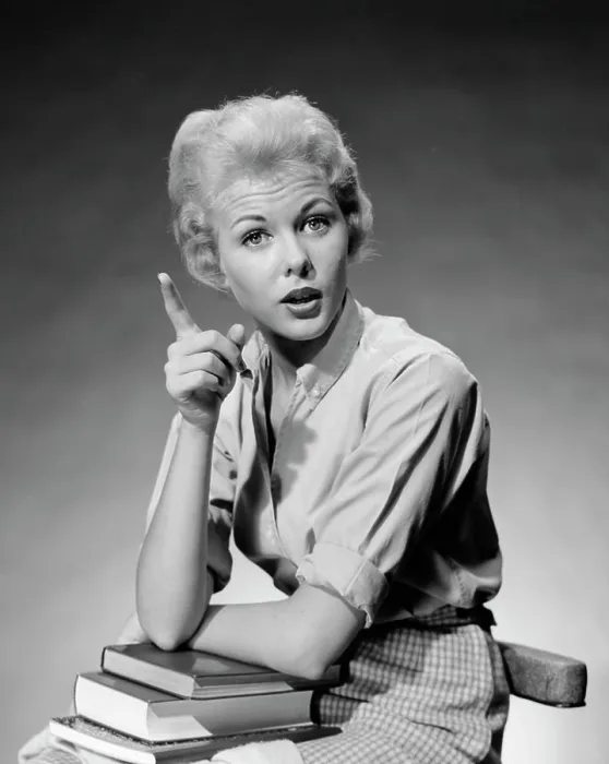 Framed Print : 1950S 1960S Blond Woman Stack Of Books In Her Lap Shaking Finger Pointing Framed Print : 1950S 1960S Blond Woman Stack Of Books In Her Lap Shaking Finger Pointing