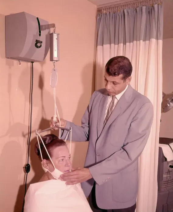 Framed Print : 1950s 1960s MAN TECHNICIAN ADJUSTING TENSION ON WOMAN PATIENT CHIN BRACE NECK TRACTION MEDICAL EQUIPMENT Framed Print : 1950s 1960s MAN TECHNICIAN ADJUSTING TENSION ON WOMAN PATIENT CHIN BRACE NECK TRACTION MEDICAL EQUIPMENT