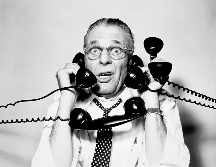 Framed Print : 1950S 1960S Portrait Of Frazzled Businessman Trying To Answer Four Black Telephones Phones At Once Framed Print : 1950S 1960S Portrait Of Frazzled Businessman Trying To Answer Four Black Telephones Phones At Once