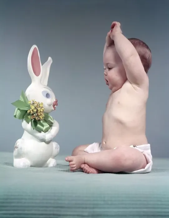 Framed Print : 1950s BABY FULL FIGURE SEATED ARMS ABOVE HEAD LOOKING AT EASTER RABBIT TOY GREEN BOW FLOWERS Framed Print : 1950s BABY FULL FIGURE SEATED ARMS ABOVE HEAD LOOKING AT EASTER RABBIT TOY GREEN BOW FLOWERS