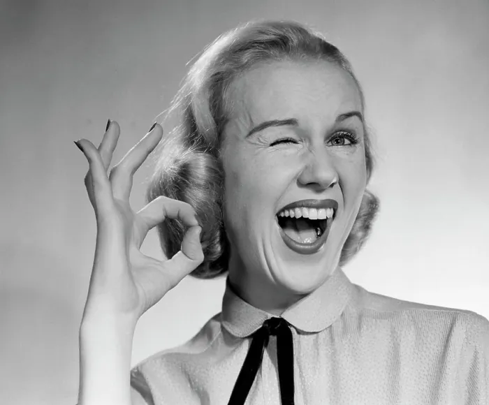 Framed Print : 1950S Blond Woman Winking Eye And Making Ok Sign With Thumb And Finger