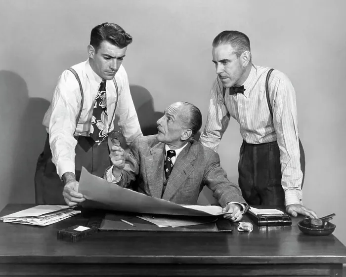 Framed Print : 1950s THREE BUSINESS MEN IN OFFICE STRATEGY CONFERENCE TWO STANDING ONE SEATED LOOKING AT PAPERS AND PLANS Framed Print : 1950s THREE BUSINESS MEN IN OFFICE STRATEGY CONFERENCE TWO STANDING ONE SEATED LOOKING AT PAPERS AND PLANS