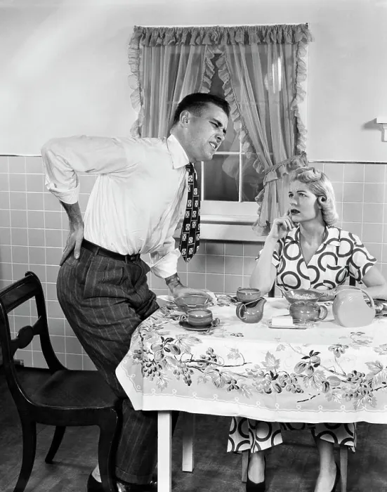 Framed Print : 1950s COUPLE AT BREAKFAST TABLE MAN WITH HAND ON HIP SUFFERING BACK PAIN Framed Print : 1950s COUPLE AT BREAKFAST TABLE MAN WITH HAND ON HIP SUFFERING BACK PAIN