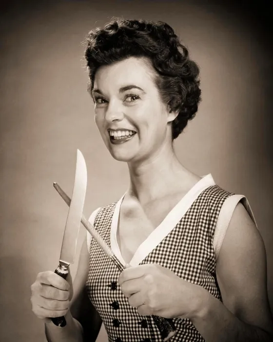 Framed Print : 1950s SMILING EAGER WOMAN HOUSEWIFE HOLDING SHARPENING CARVING KNIFE LOOKING AT CAMERA