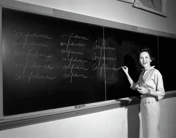 Framed Print : 1950S Teacher In Front Of Classroom Writing Confidence On Blackboard Framed Print : 1950S Teacher In Front Of Classroom Writing Confidence On Blackboard