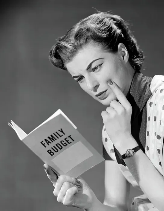 Framed Print : 1950S Woman In Apron Finger On Cheek Looking At Family Budget Book Framed Print : 1950S Woman In Apron Finger On Cheek Looking At Family Budget Book