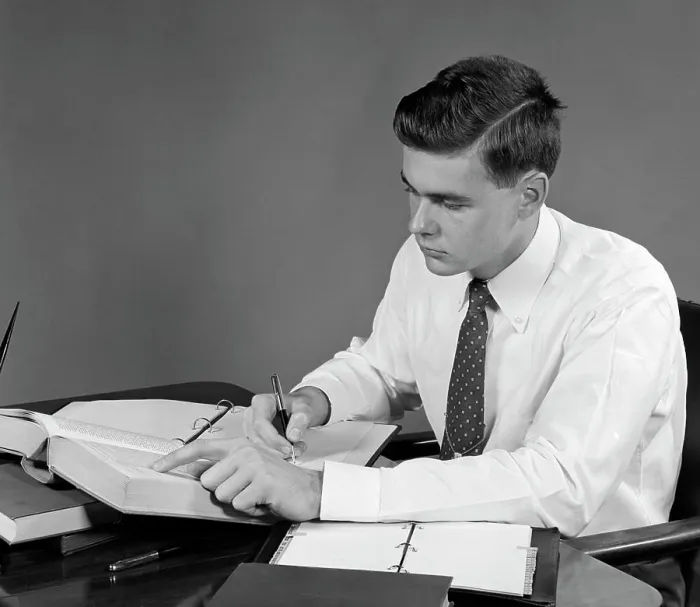 Framed Print : 1950S Young Man Sitting At Desk Studying