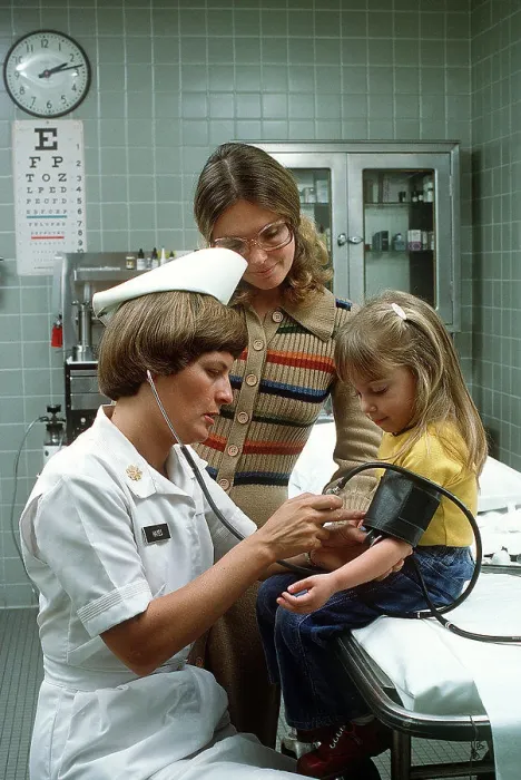 Framed Print : 1977 - A nurse takes a child's blood pressure Framed Print : 1977 - A nurse takes a child's blood pressure