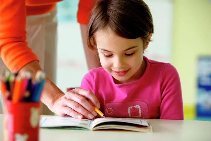 Framed Print : 6 years old girl at school with teacher Framed Print : 6 years old girl at school with teacher