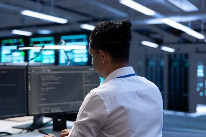 Framed Print : Admin in data center using diagnostic tools and system monitoring software on computer to identify root cause of errors