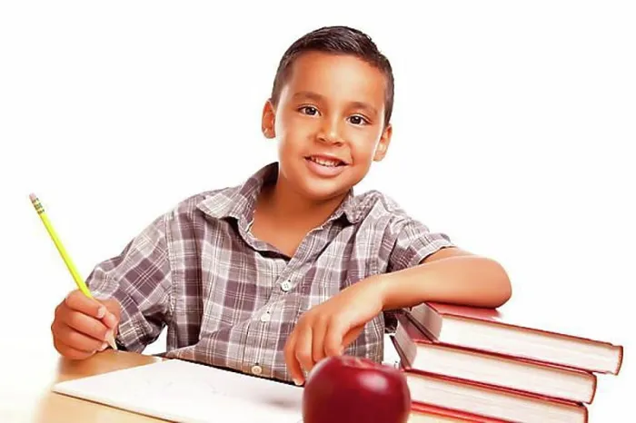 Framed Print : Adorable hispanic boy with books, apple, pencil and paper isolated on a white background Framed Print : Adorable hispanic boy with books, apple, pencil and paper isolated on a white background
