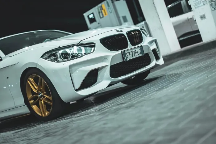 Framed Print : Adria, Italy 30 july 2024: View of a BMW Series 1 with gold wheels parked at night Framed Print : Adria, Italy 30 july 2024: View of a BMW Series 1 with gold wheels parked at night