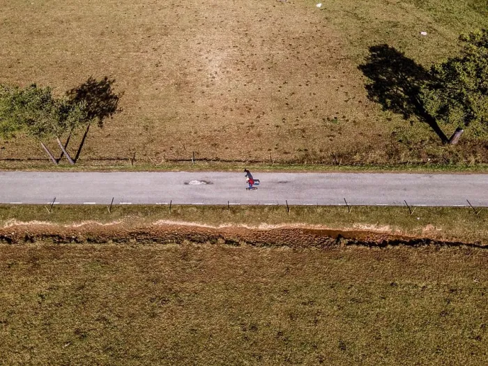 Framed Print : Aerial overhead view of skateboarding man in a mountain road Framed Print : Aerial overhead view of skateboarding man in a mountain road