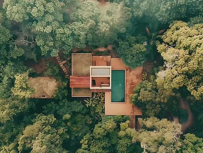 Framed Print : Aerial shot of a secluded house with a swimming pool surrounded by dense greenery
