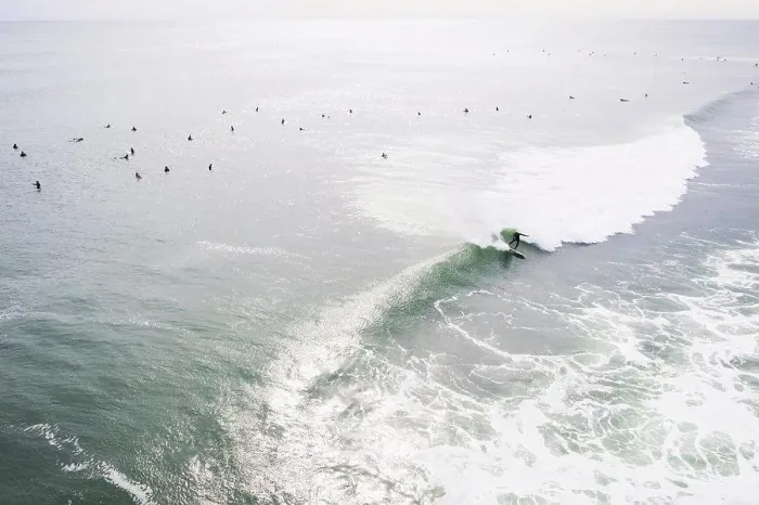 Framed Print : Aerial of Surfers on long hurricane waves in Rhode Island