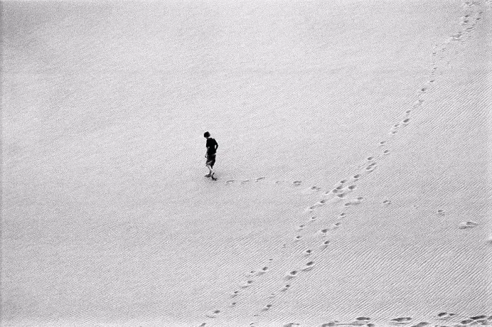 Framed Print : Aerial View of Boy Walking Across Sand Dune Framed Print : Aerial View of Boy Walking Across Sand Dune