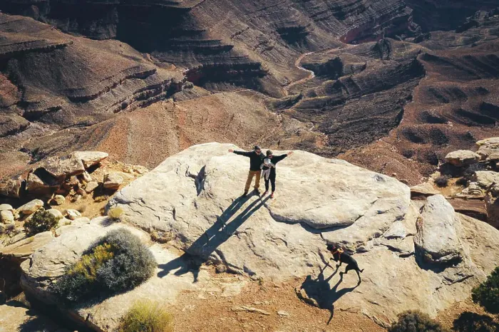 Framed Print : Aerial view of a family standing on a cliff of a Utah canyon