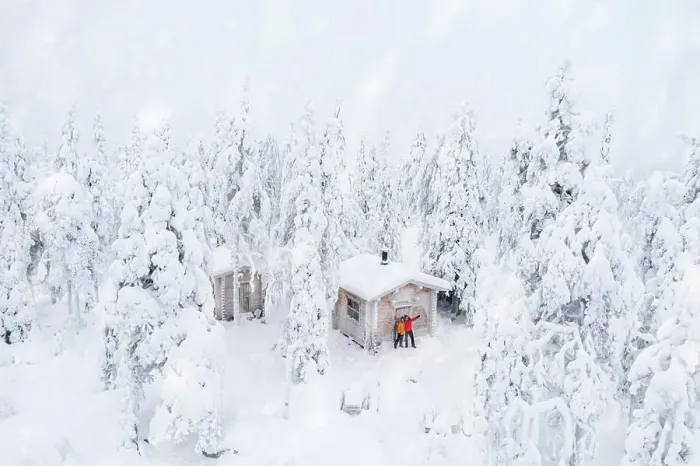 Framed Print : Aerial view of happy couple enjoying the winter holidays in a frozen hut in the snowy forest Framed Print : Aerial view of happy couple enjoying the winter holidays in a frozen hut in the snowy forest