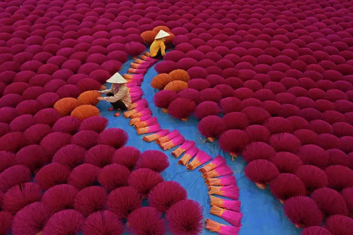Framed Print : Aerial view of incense workers sits surrounded by thousands of incense sticks Framed Print : Aerial view of incense workers sits surrounded by thousands of incense sticks