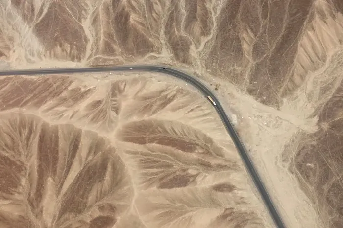Framed Print : Aerial view of a lonely road snaking through a barren desert landscape Framed Print : Aerial view of a lonely road snaking through a barren desert landscape
