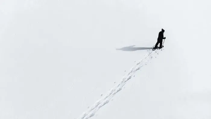 Framed Print : Aerial view of man snowshoeing across an empty snowy landcsape Framed Print : Aerial view of man snowshoeing across an empty snowy landcsape