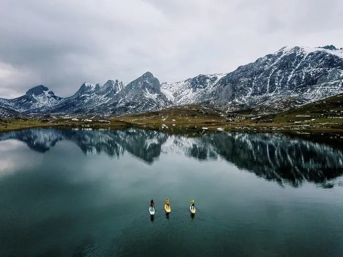 Framed Print : Aerial view of three people stand up paddle surfing, Leon, Spain Framed Print : Aerial view of three people stand up paddle surfing, Leon, Spain