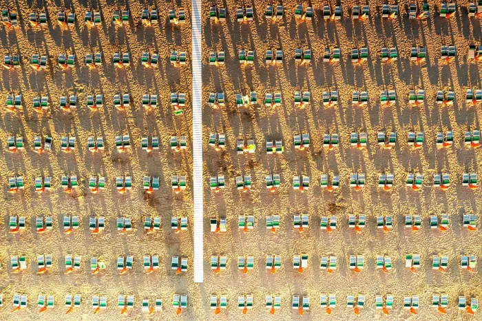 Framed Print : Aerial view of rows of lounge chairs and sunbeds on empty sand beach Framed Print : Aerial view of rows of lounge chairs and sunbeds on empty sand beach