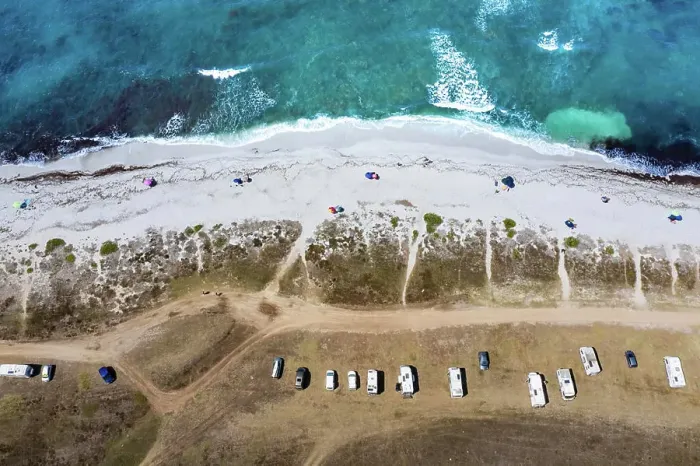 Framed Print : Aerial view of a serene beach with parked cars and clear waters Framed Print : Aerial view of a serene beach with parked cars and clear waters